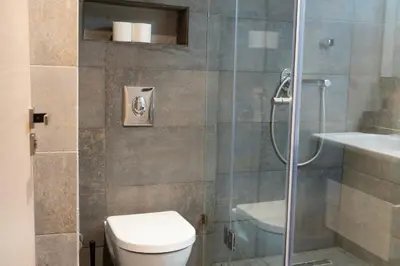 a bathroom with a toilet and a glass shower at Prime location unmatched comfort in Casablanca