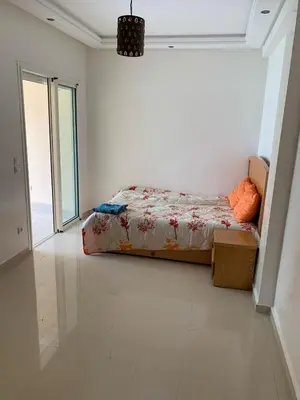 a bedroom with a bed in a white room at ola blanca in Sidi Rahal