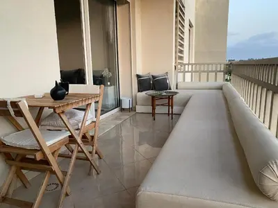 a balcony with a couch and a table at Dar Bouazza piscine Bab Rayan in Casablanca