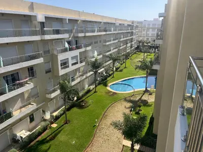 an apartment building with a courtyard and a swimming pool at Les Jardins de Bouznika Premium - Votre espace familial in Bouznika