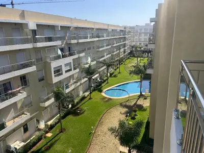 an apartment building with a courtyard with a swimming pool at Les Jardins de Bouznika Premium - Votre espace familial in Bouznika