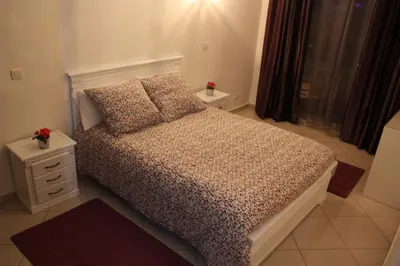 a small bedroom with a bed and a night stand at Bienvenue à Casablanca centre idéal pro ou famille in Casablanca