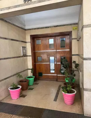 a building with potted plants in front of a door at Bienvenue à Casablanca centre idéal pro ou famille in Casablanca