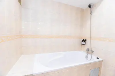 a bath tub in a bathroom with a sink at Cozy apartment 5 minutes from Casa Voyageurs in Casablanca