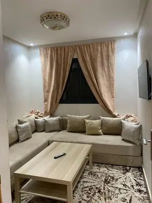 a living room with a couch and a table at Appartement meublé a sidi rahal in Sidi Rahal
