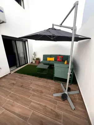 a living room with a couch and an umbrella at Great for families and couples in Casablanca