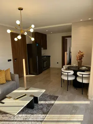 a living room with a couch and a table at Beautiful apartment in Tadart in Casablanca