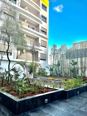 a garden in front of a building at Beautiful apartment in Tadart in Casablanca