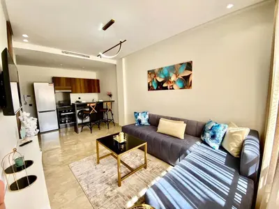 a living room with a couch and a table at Très beau appartement a tadart au centre de casablanca in Casablanca