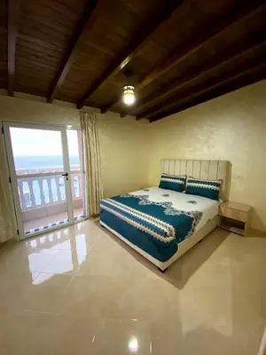 a bedroom with a bed and a large window at Riad sultan in Casablanca