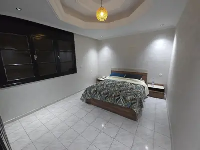 a bedroom with a bed in the corner of a room at Faridi house in Casablanca