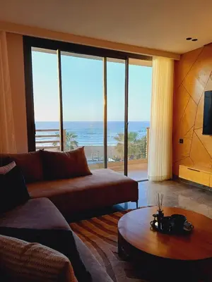 a living room with a couch and a view of the ocean at Panoramic ocean view appartement in Casablanca