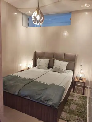 a large bed in a bedroom with two lamps at Wafa in Casablanca