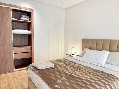 a bedroom with a large bed and a closet at Appartement Oasis in Casablanca