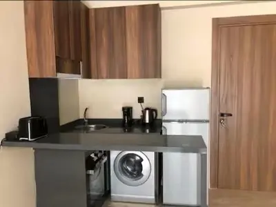 a kitchen with a sink and a refrigerator at Appartement Oasis in Casablanca