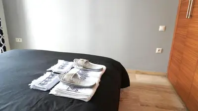 a pair of shoes sitting on top of a bed at Appartement Sacré-Cœur in Casablanca