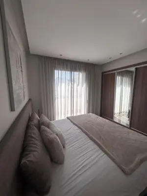 a bedroom with a large bed with pillows and a mirror at Anfa Casablanca in Casablanca