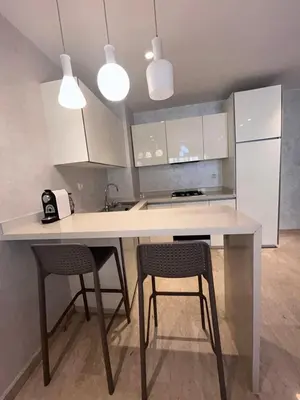 a kitchen with a white table and two chairs at Anfa Casablanca in Casablanca