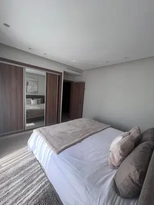 a bedroom with a large bed and a large window at Anfa Casablanca in Casablanca