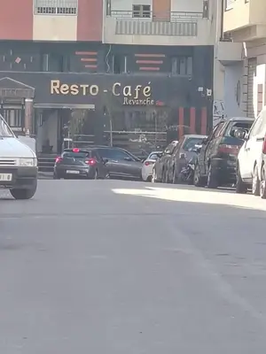 a street with cars parked in front of a restaurant at casa bella in Casablanca