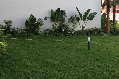 a green yard with a sign in the grass at Your comfortable stopover in Nouaseur