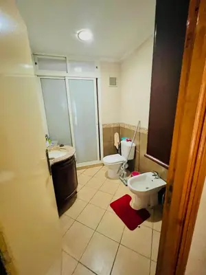 a bathroom with a toilet and a sink at Apparemment à louer au centre ville Bouznika in Bouznika