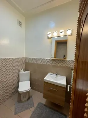 a bathroom with a sink and a toilet and a mirror at Kawtar in Pont Blondin