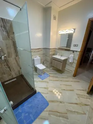 a bathroom with a shower and a toilet and a sink at Kawtar in Pont Blondin