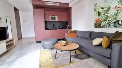 a living room with a blue couch and a table at Modern apartment in Casablanca in Casablanca