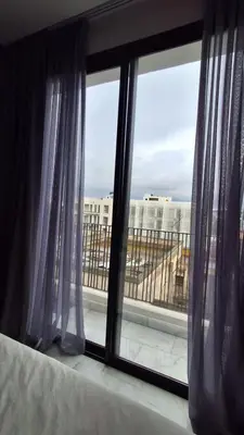 a bedroom window with a view of a building at Modern apartment in Casablanca in Casablanca