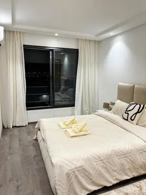 a bedroom with a large bed with a large window at Beautiful spacious apartment in Casablanca in Casablanca