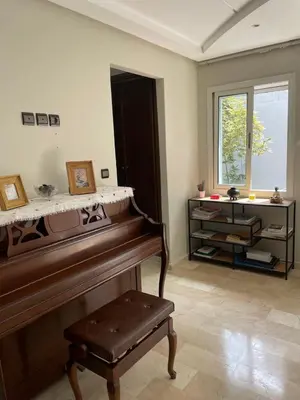 a living room with a piano and a window at Chambres Surf,Piano et Arts in Tamaris