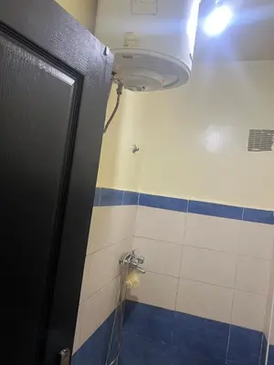 a bathroom with a shower with blue and white tiles at Appartement farah salam oulfa in Casablanca