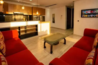 a living room with two red couches and a table at 1BR - Casa Voyageurs - Belvedere in Maarif