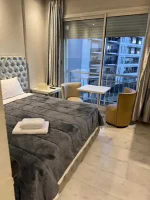 a hotel room with a large bed and a balcony at Nice Studio rabat in Rabat