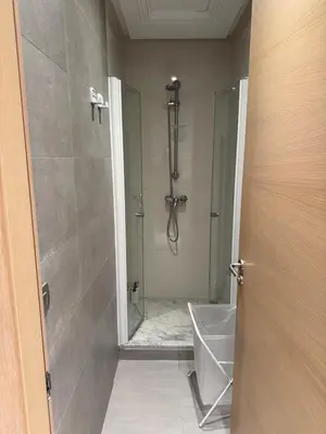 a bathroom with a shower with a glass door at Nice Studio rabat in Rabat