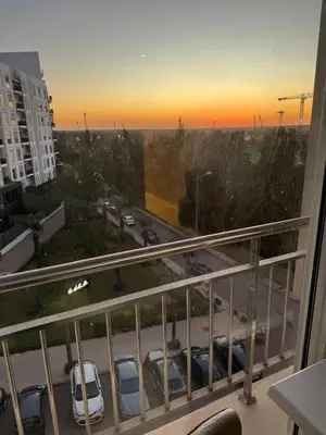 a balcony with a view of a parking lot with cars at Nice Studio rabat in Rabat