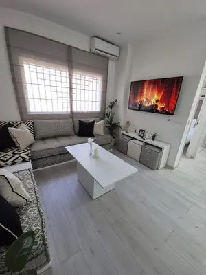 a living room with a couch and a table at Studio close to Descartes high school in Rabat