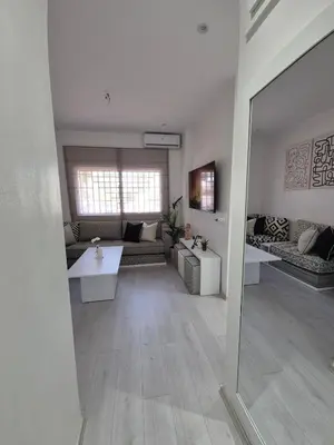 a living room with a couch and a table at Studio close to Descartes high school in Rabat
