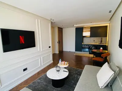 a living room with a tv on the wall at spectrum studio in Casablanca
