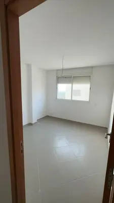 an empty room with a window and a white floor at dekra bouznika in Bouznika