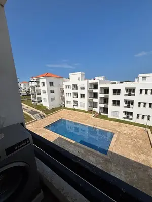 a view of a swimming pool from a building at Apartment with pool view, 1 min to beach, private parking in Pont Blondin