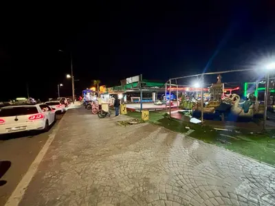 a street at night with cars parked on the road at Apartment with pool view, 1 min to beach, private parking in Mansouria