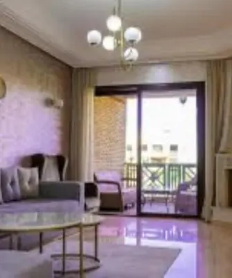 a living room with a couch and a table at Appartement CFC vue sur mer et sur la ville in Anfa