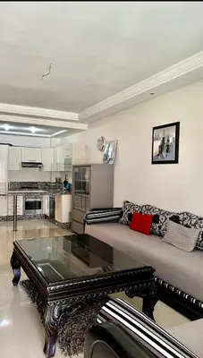 a living room with a couch and a glass table at Ola Blanca in Sidi Rahal