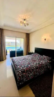 a bedroom with a bed with a blanket on it at Ola Blanca in Sidi Rahal