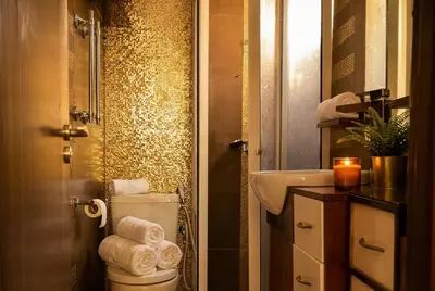 a bathroom with a toilet and a sink with a candle at Spacious City Bourgogne in Maarif