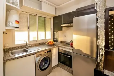 a kitchen with a stainless steel refrigerator and a dishwasher at Spacious City Bourgogne in Maarif