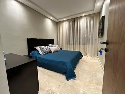 a bedroom with a bed with blue sheets and pillows at 3 Rooms & View in Casablanca