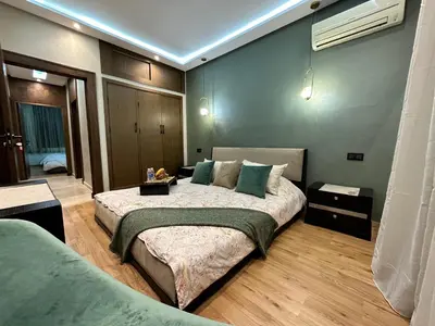 a bedroom with a large bed with green pillows at 3 Rooms & View in Casablanca